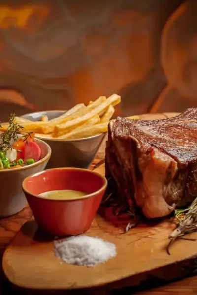 Beef steak frites with side salad and sauce at LAO Marrakech
