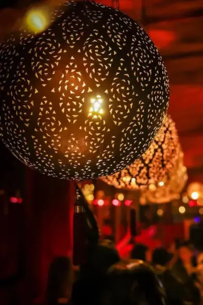 Intricate Moroccan metal lanterns hanging at Palais Jad Mahal restaurant in Marrakech