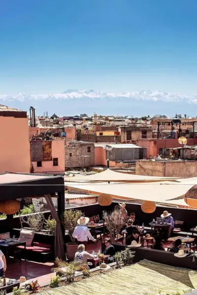 Panoramic view of the Marrakech rooftop terrace and the Atlas Mountains beyond, from Terrasse des Épices
