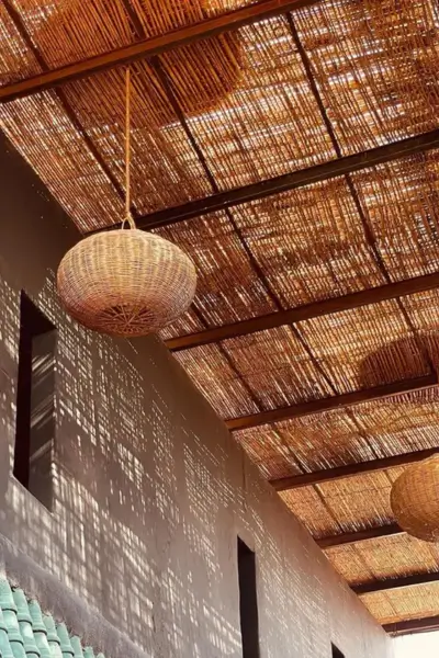Detail of the woven reed ceiling casting patterned light and shadow at Terrasse des Épices, Marrakech